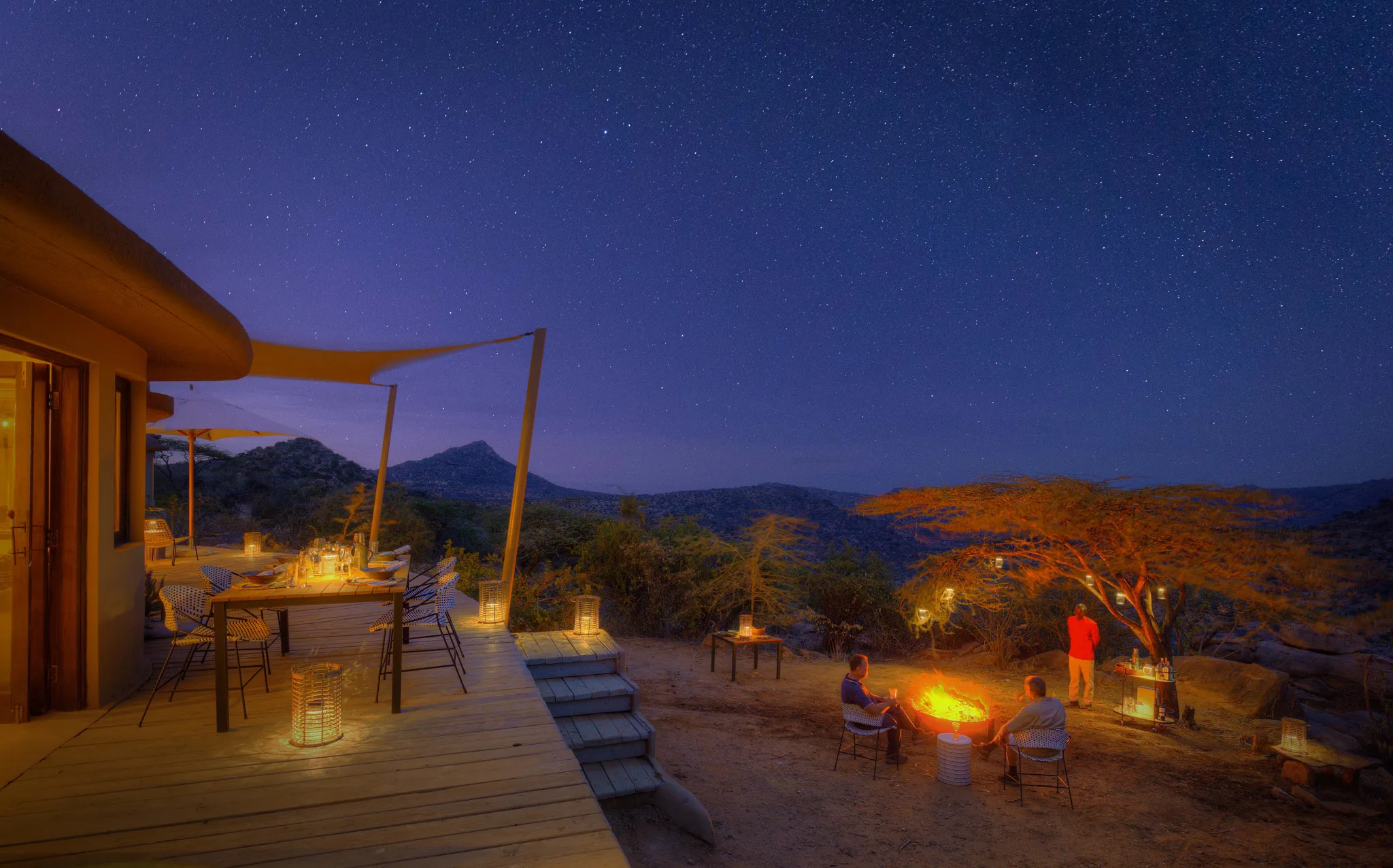 drinks around campfire at Boscia house